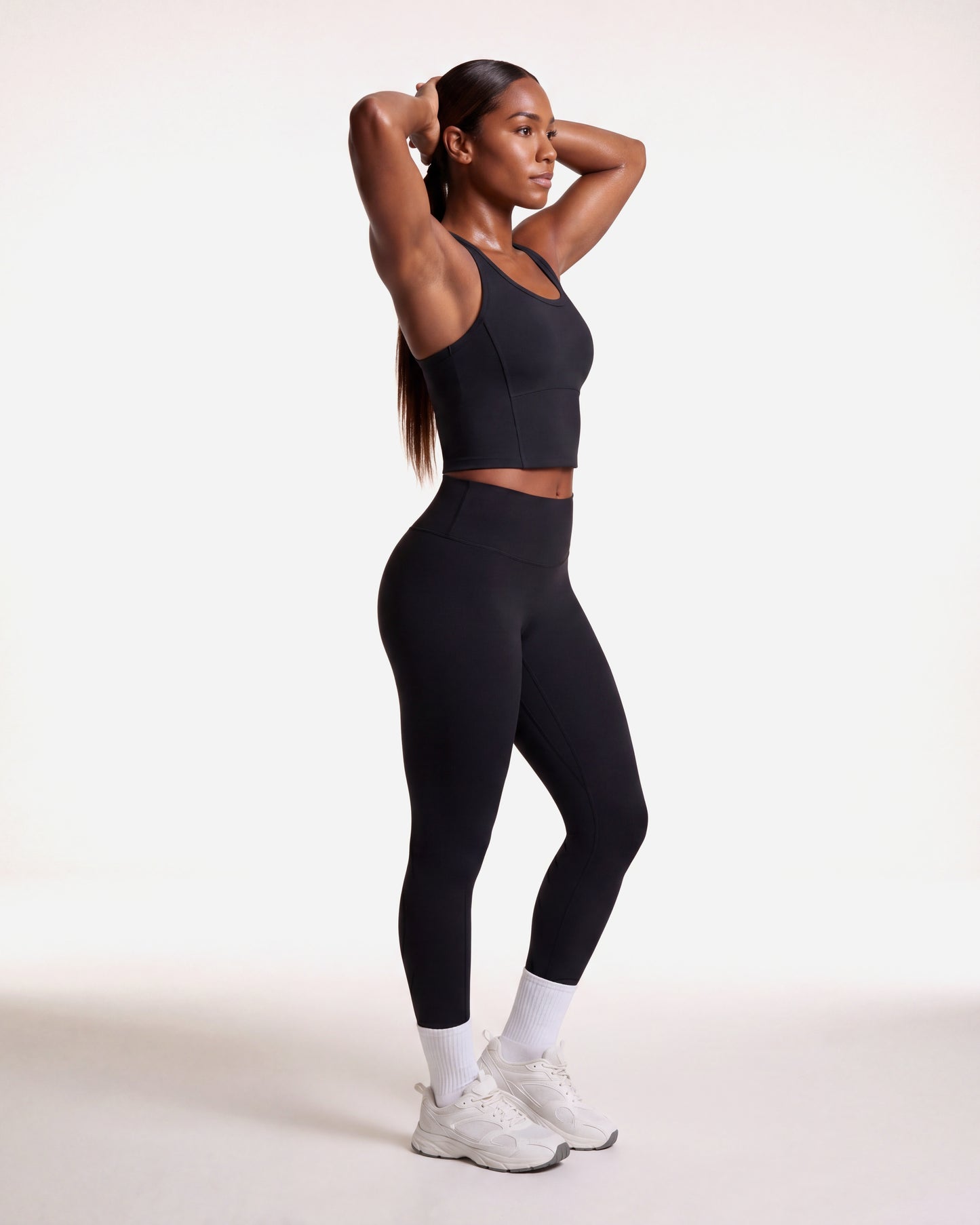 VARCEA Seamless High Tank in black — lifestyle, arms raised